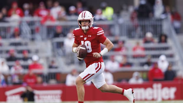Oct 14, 2023; Madison, Wisconsin, USA; Wisconsin Badgers quarterback Braedyn Locke (18) looks to throw a pass during the third quarter against the Iowa Hawkeyes at Camp Randall Stadium. Mandatory Credit: Jeff Hanisch-USA TODAY Sports